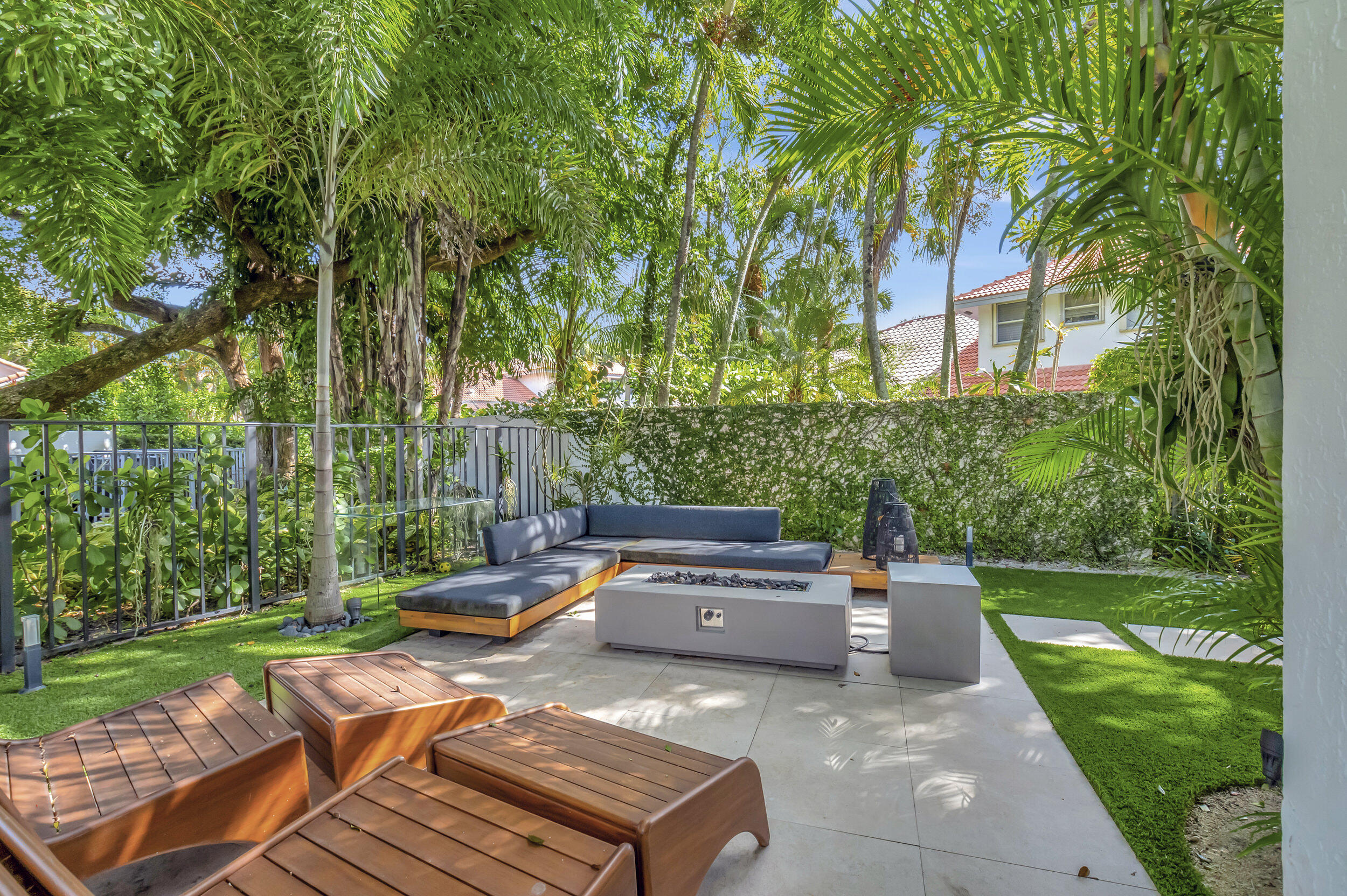 5254 Northwest 22nd Avenue Boca Raton, FL 33496 - Photo 37 of 50 a backyard of a house with fountain table and chairs
