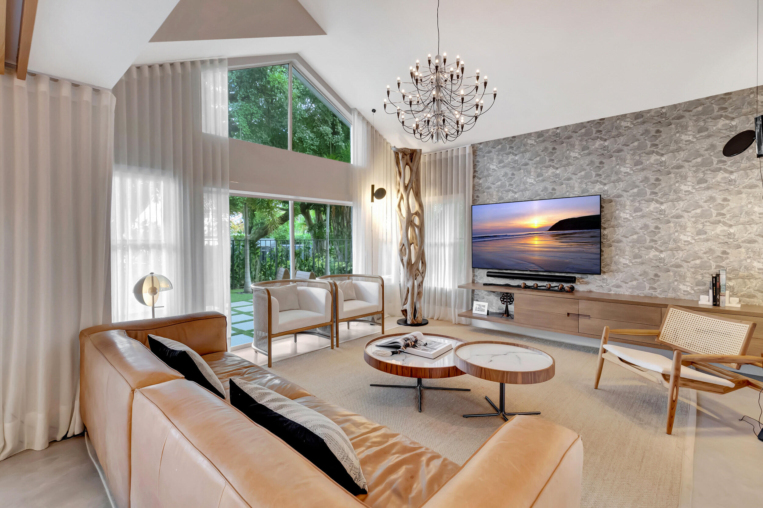 5254 Northwest 22nd Avenue Boca Raton, FL 33496 - Photo 7 of 50 a living room with furniture a chandelier and a flat screen tv