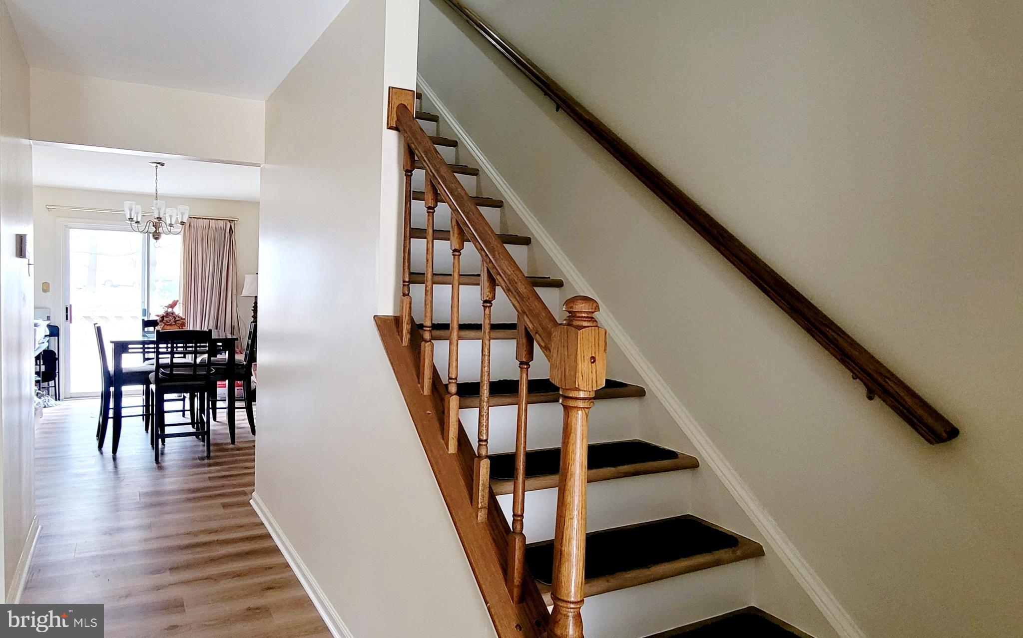 8902 Winding Hollow Way Springfield, VA 22152 - Photo 12 of 17 a view of entryway with wooden floor and stairs