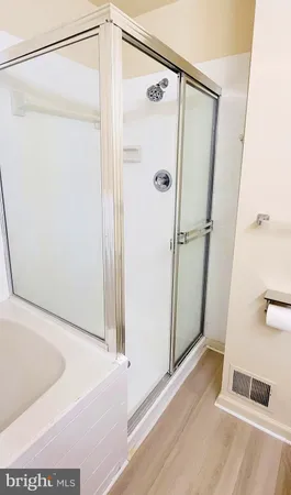 a bathroom with a bathtub and a shower