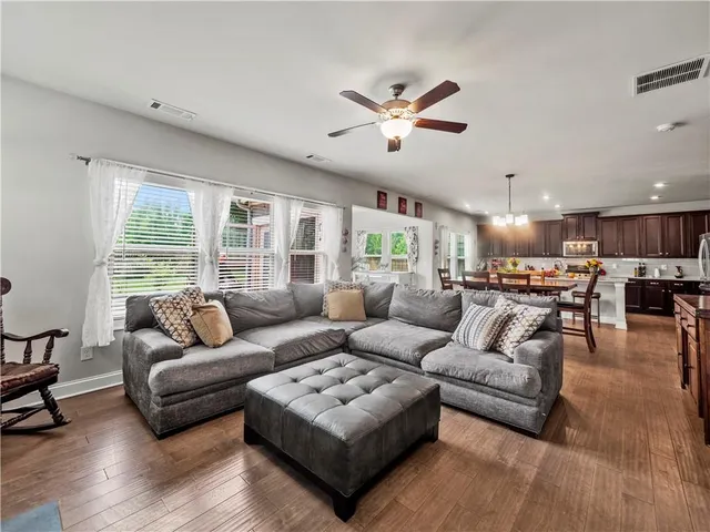 a large kitchen with kitchen island a sink table and chairs