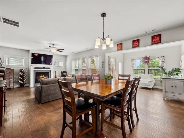 a kitchen with stainless steel appliances granite countertop a sink refrigerator and cabinets