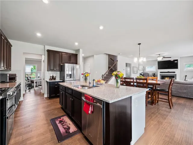 a dining room with furniture a chandelier and wooden floor