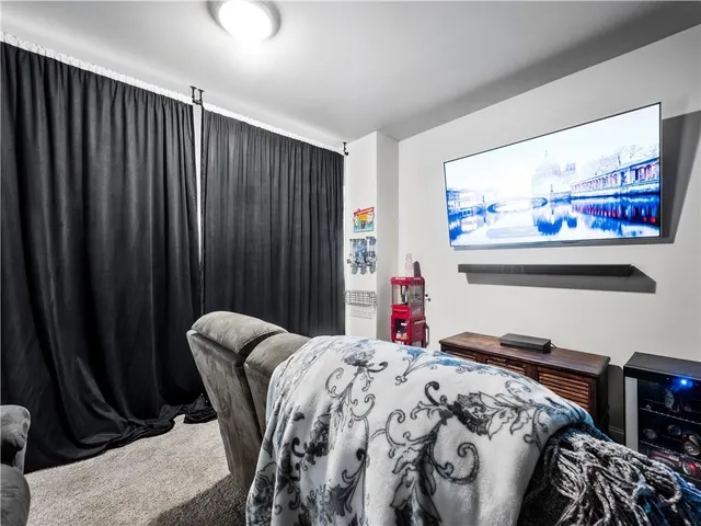 a spacious bedroom with a bed and dresser