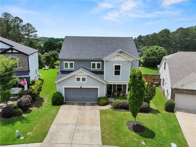 a front view of a house with garden