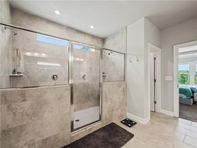 a bathroom with a toilet a sink a mirror a window and vanity