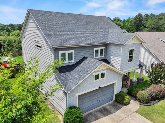 a aerial view of a house next to a yard