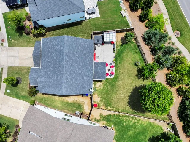 an aerial view of a house with swimming pool and outdoor space