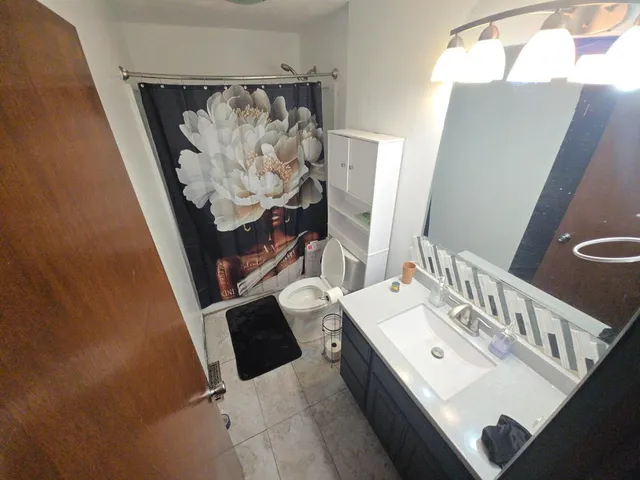 a bathroom with a bathtub sink and mirror