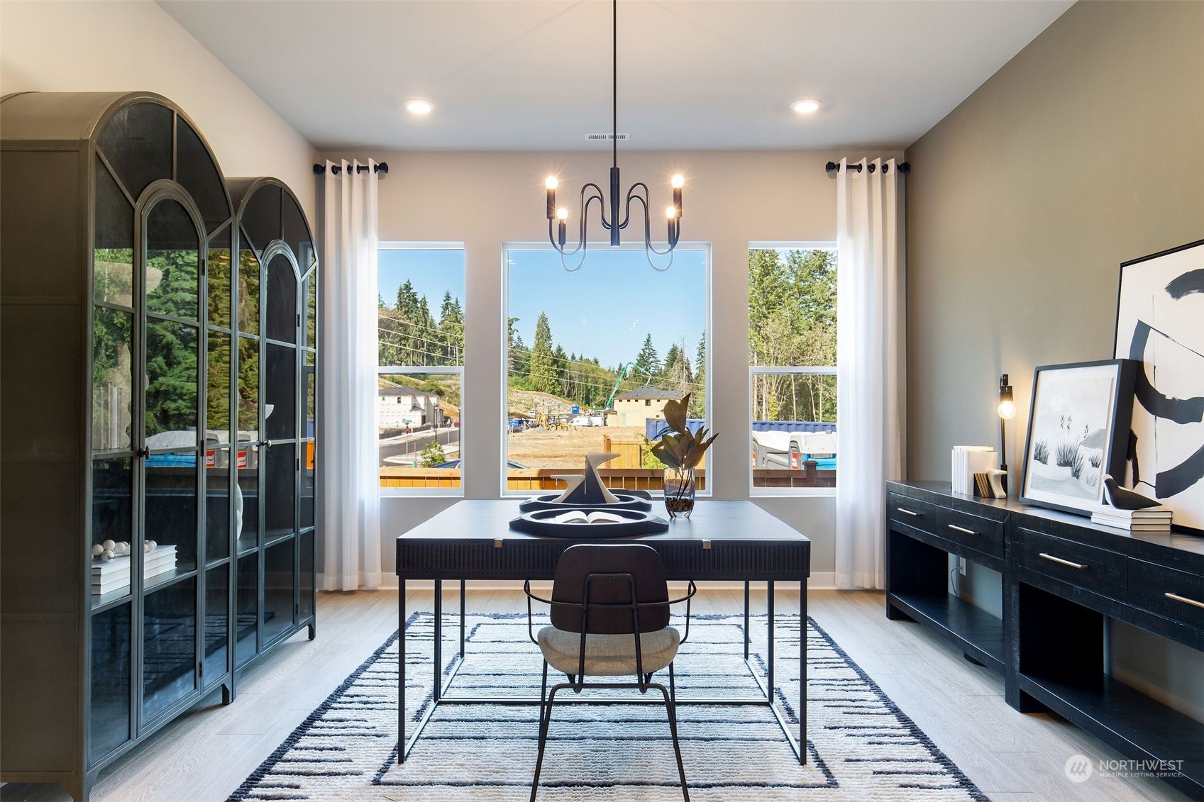 3900 Northeast 27th Place, Unit 3 Renton, WA 98059 - Photo 13 of 37 a dining room with furniture a chandelier and glass door