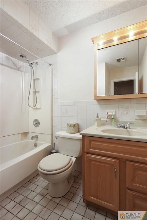 2 Rumson Road Kendall Park, NJ 08824 - Photo 15 of 28 a bathroom with a granite countertop sink toilet a mirror a bathtub and shower