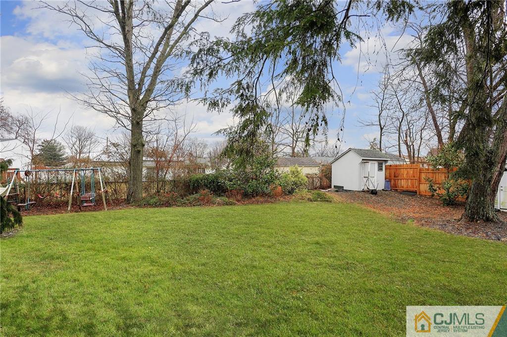 2 Rumson Road Kendall Park, NJ 08824 - Photo 27 of 28 a backyard of a house with table and chairs
