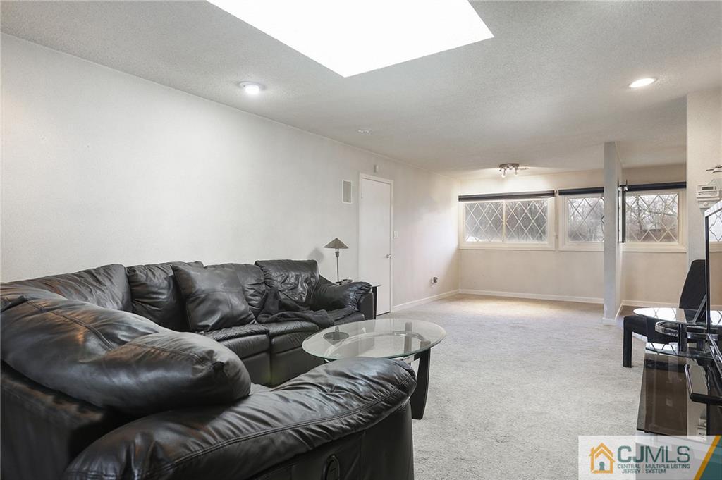 2 Rumson Road Kendall Park, NJ 08824 - Photo 6 of 28 a living room with furniture and a flat screen tv