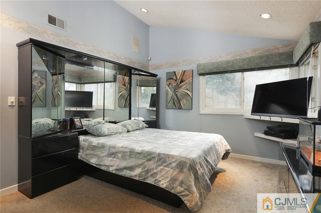 2 Rumson Road Kendall Park, NJ 08824 - Photo 9 of 28 a bedroom with a bed and a flat screen tv