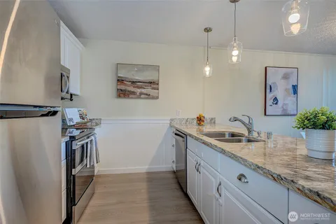 a kitchen with a sink and a refrigerator