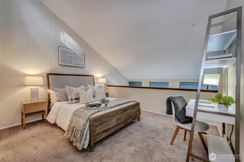 a bedroom with a bed a desk and chair