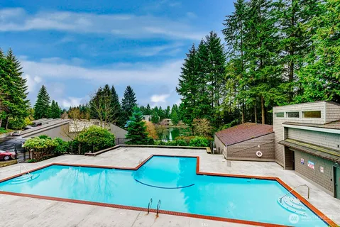 a view of a backyard with swimming pool
