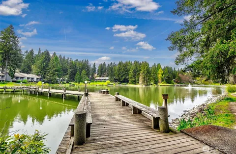 a view of a lake with a wooden bridge