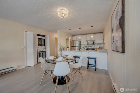 a view of a dining room with furniture and wooden floor