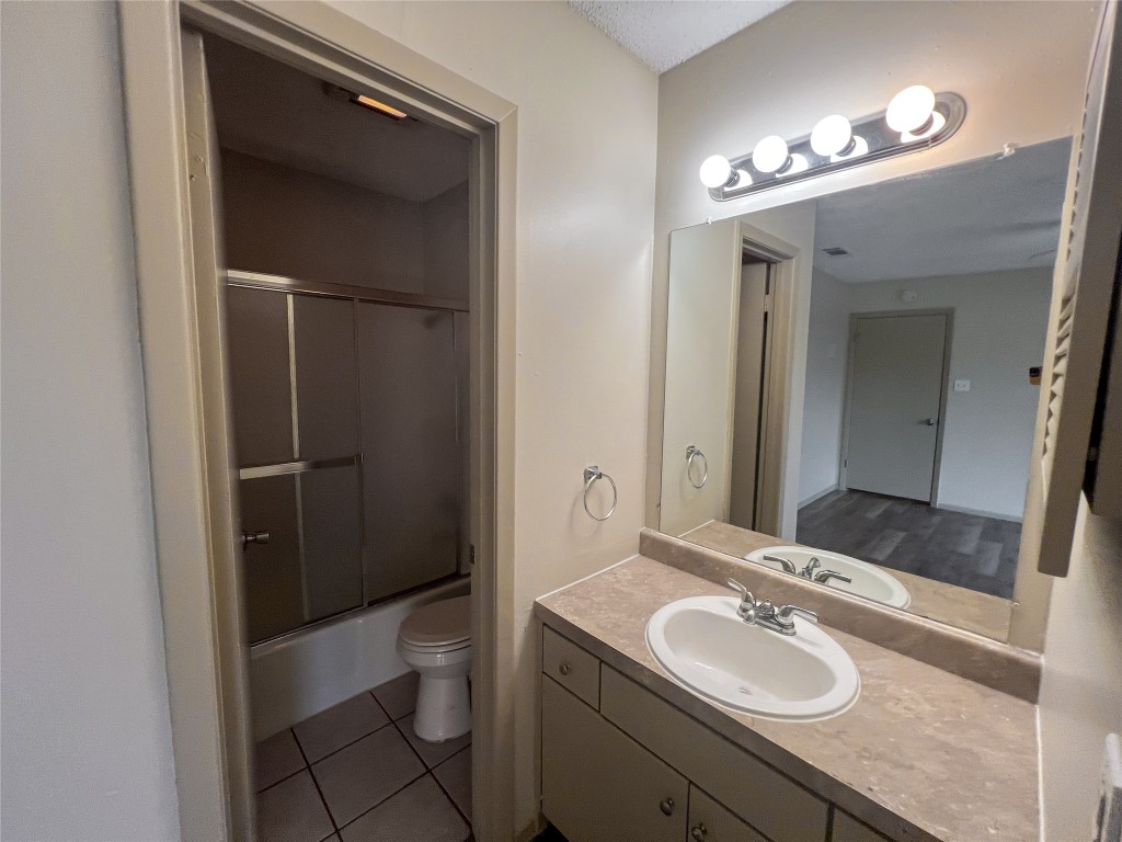 7206 Creekside Drive, Unit C Austin, TX 78752 - Photo 15 of 22 a bathroom with a sink a toilet and shower