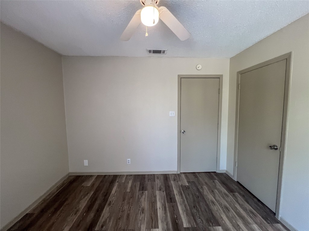 7206 Creekside Drive, Unit C Austin, TX 78752 - Photo 16 of 22 an empty room with wooden floor and windows