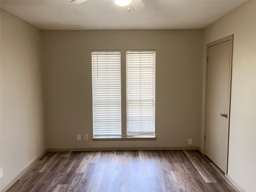 7206 Creekside Drive, Unit C Austin, TX 78752 - Photo 17 of 22 an empty room with wooden floor and windows