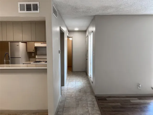 an empty room with windows and a fireplace