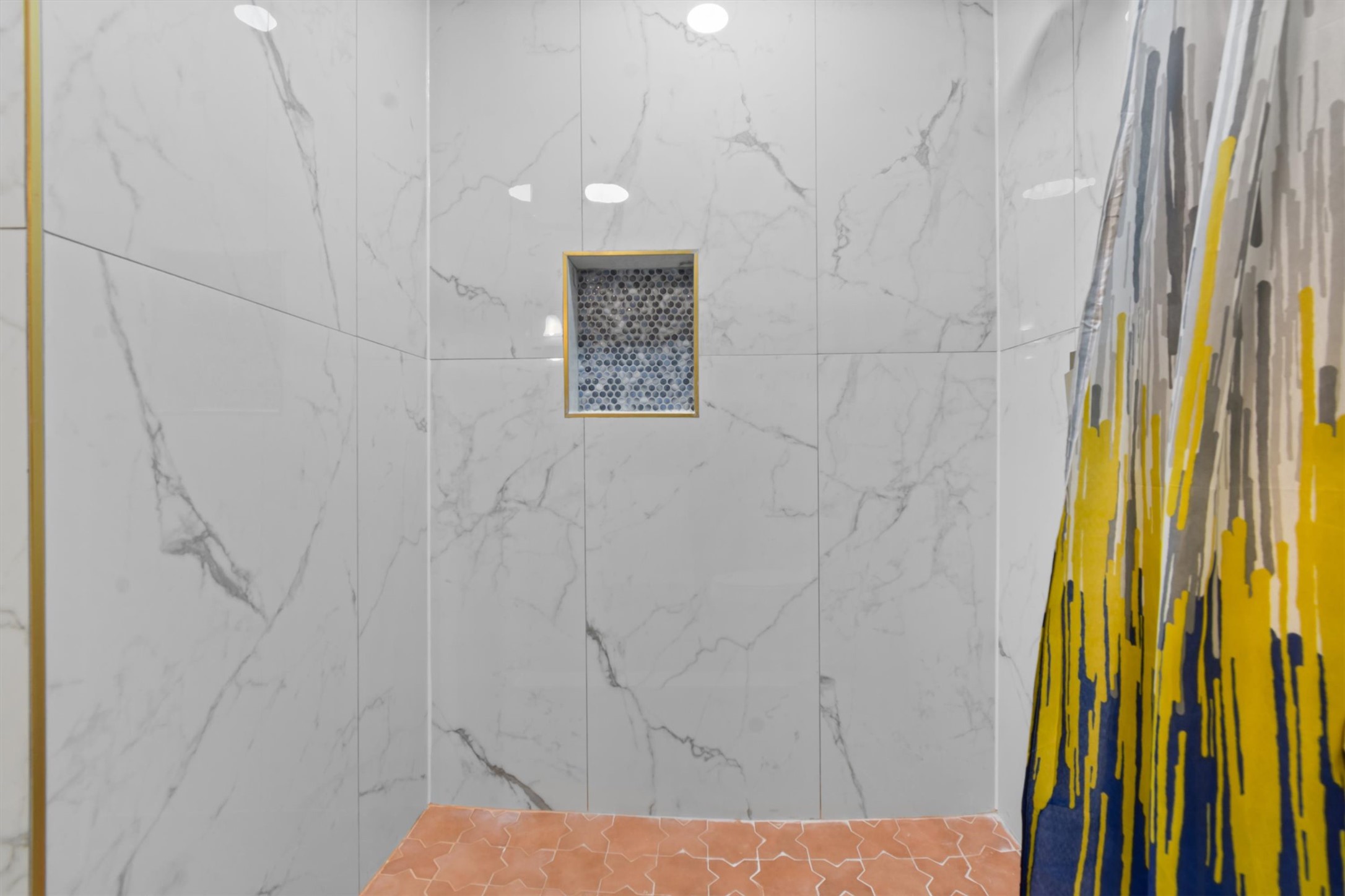 9100 Highway 183 Austin, TX 78747 - Photo 27 of 38 Gleaming marble-patterned wall tiles and a built-in niche elevate this modern shower space.