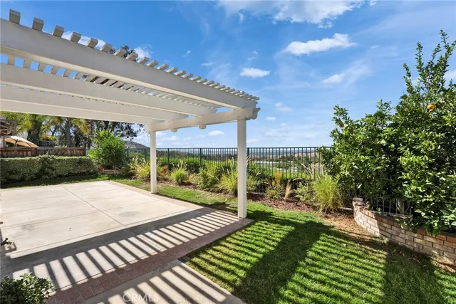 a view of a patio with a table and chairs under an umbrella