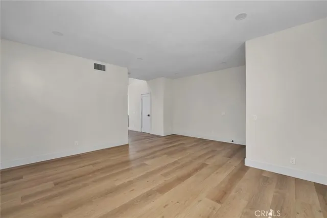 a view of an empty room and wooden floor