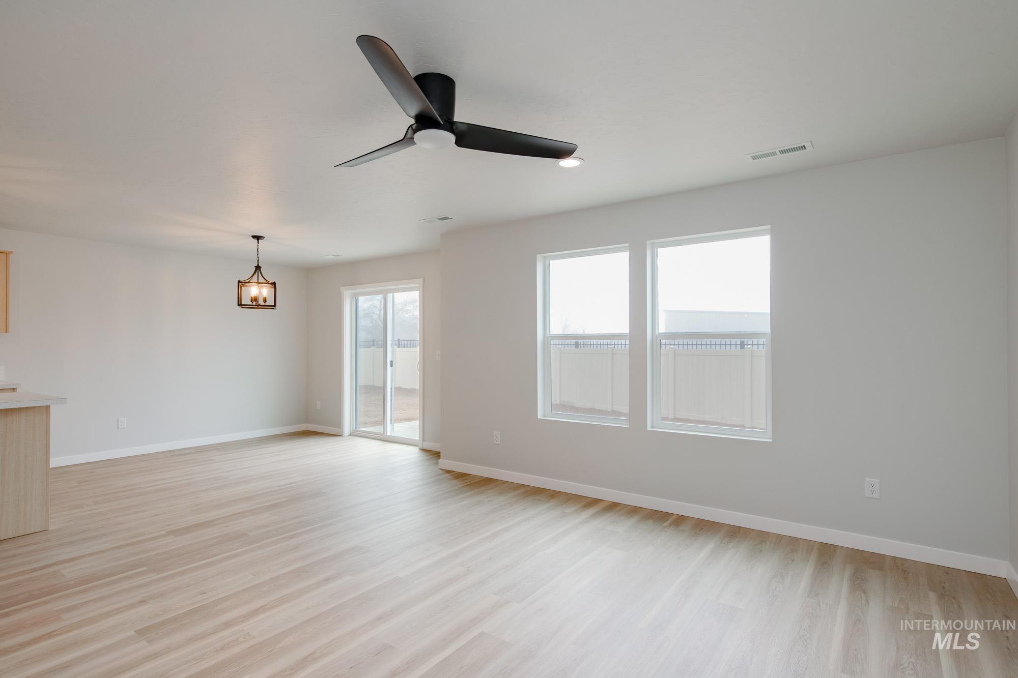 2391 West Fallon Loop Nampa, ID 83651 - Photo 7 of 20 Open concept living space featuring light wood-finish flooring and neutral wall tones