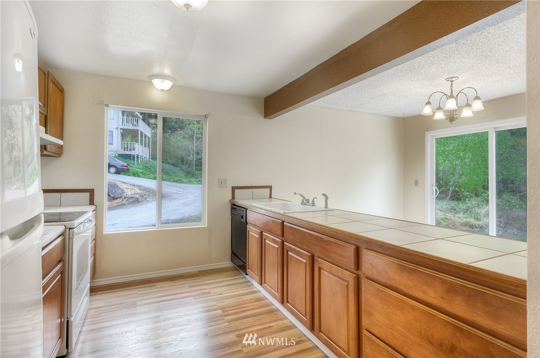 13933 Southeast Allen Road Bellevue, WA 98006 - Photo 3 of 11 a view of a kitchen with a sink and wooden floor