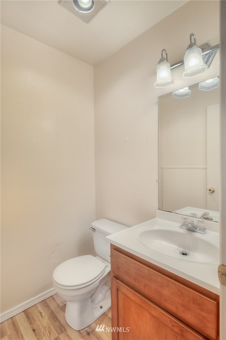 13933 Southeast Allen Road Bellevue, WA 98006 - Photo 9 of 11 a bathroom with a granite countertop toilet and a sink