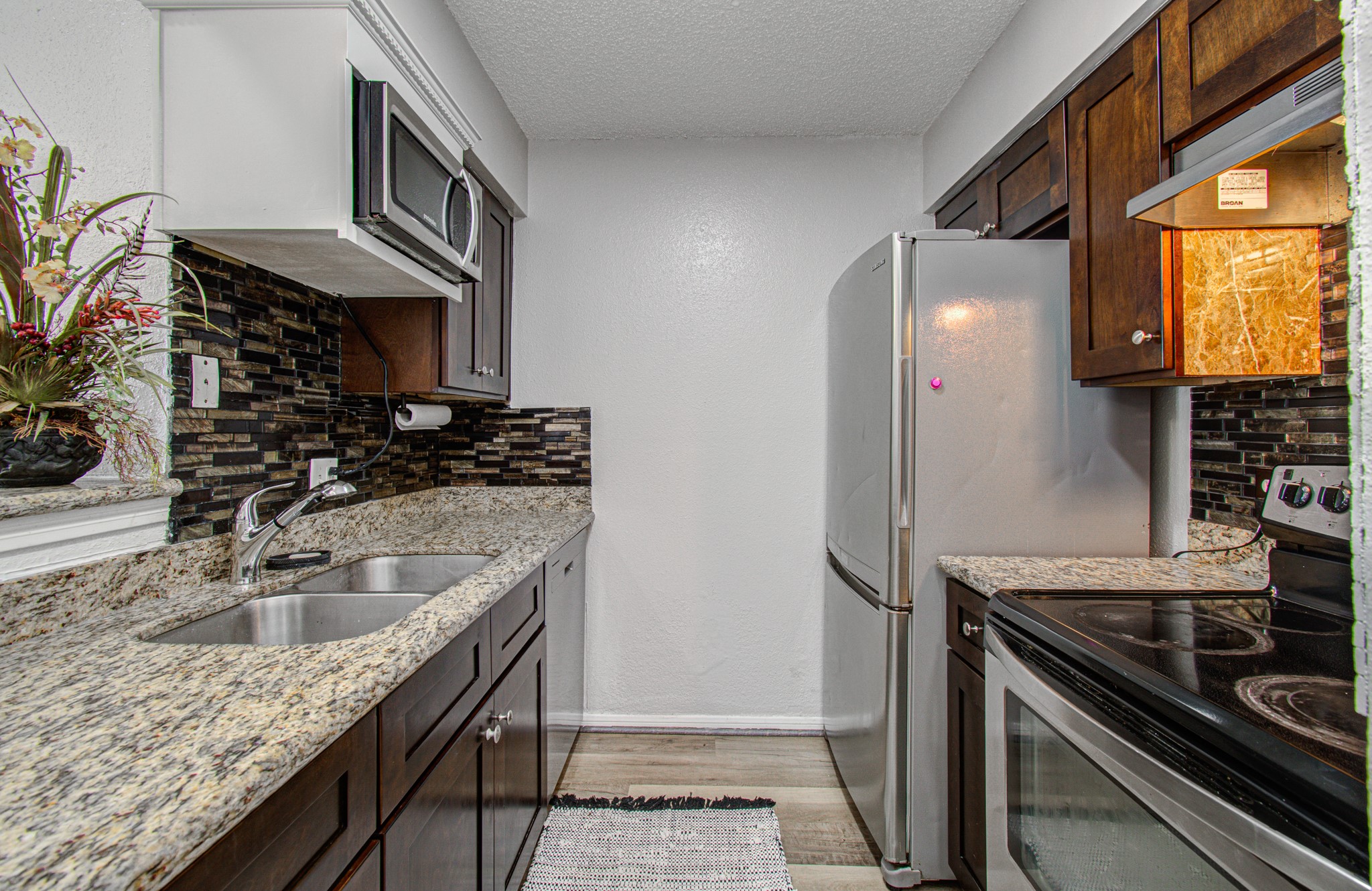 10101 South Gessner Road, Unit 405 Houston, TX 77071 - Photo 2 of 27 a kitchen with stainless steel appliances granite countertop a sink stove and refrigerator