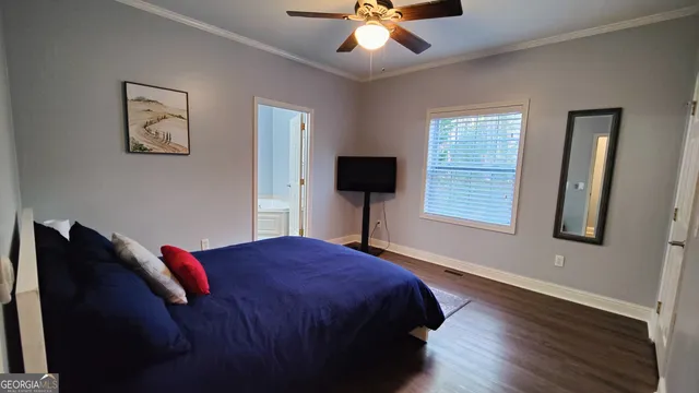 a bedroom with a bed and a rug