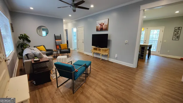 a living room with furniture and a flat screen tv