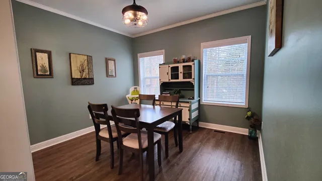 a view of a dining room with furniture and wooden floor