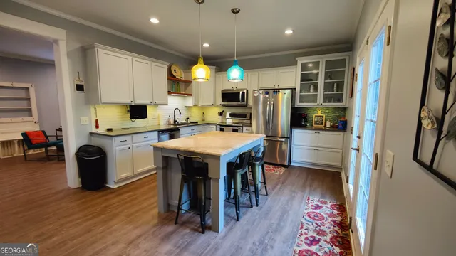 a kitchen with a sink appliances and cabinets