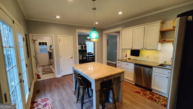 a kitchen with stainless steel appliances granite countertop a refrigerator and a stove top oven