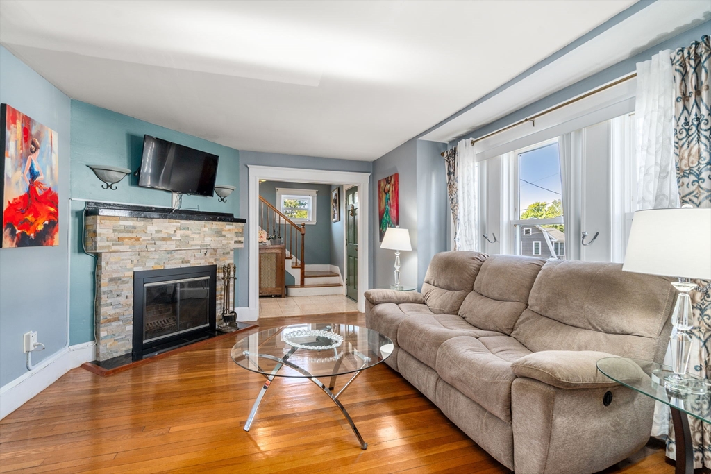 87 Waldeck Road Milton, MA 02186 - Photo 11 of 21 a living room with furniture fireplace and flat screen tv
