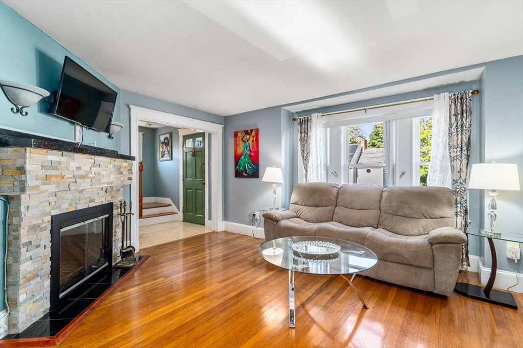87 Waldeck Road Milton, MA 02186 - Photo 12 of 21 a living room with furniture fireplace and a flat screen tv