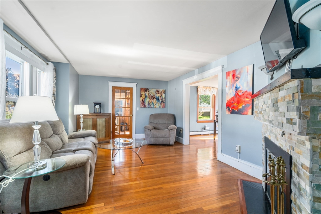 87 Waldeck Road Milton, MA 02186 - Photo 13 of 21 a living room with furniture and a flat screen tv