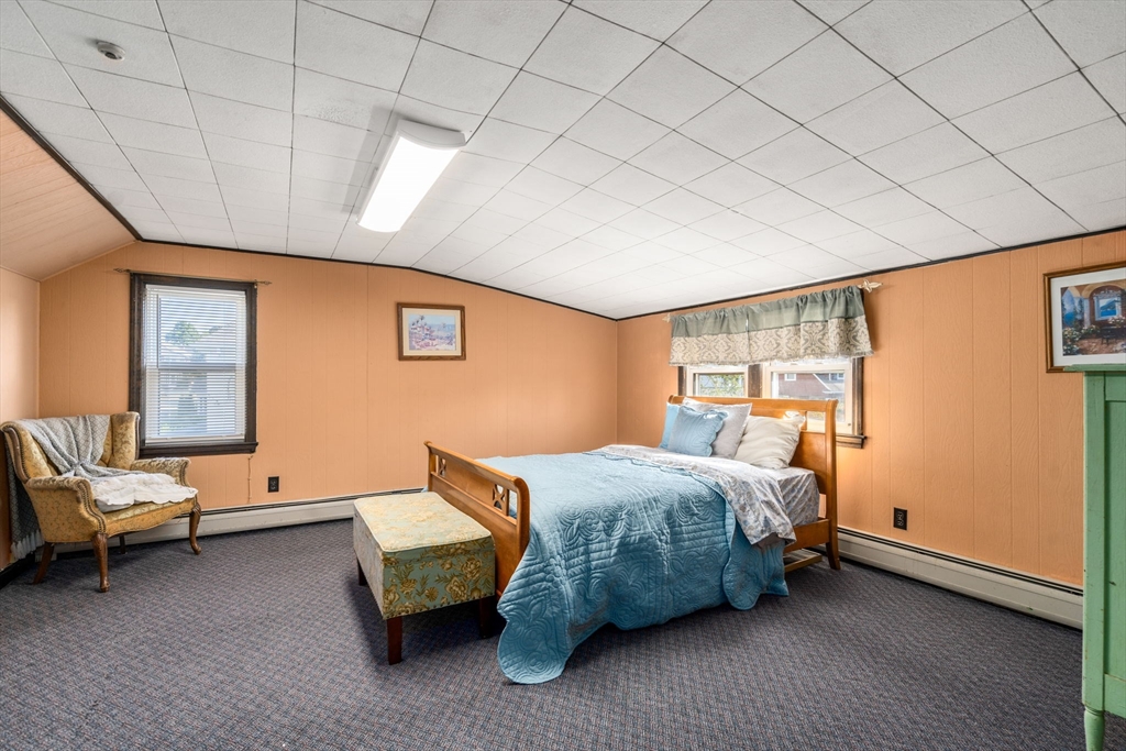 87 Waldeck Road Milton, MA 02186 - Photo 14 of 21 a bedroom with a bed and a couch