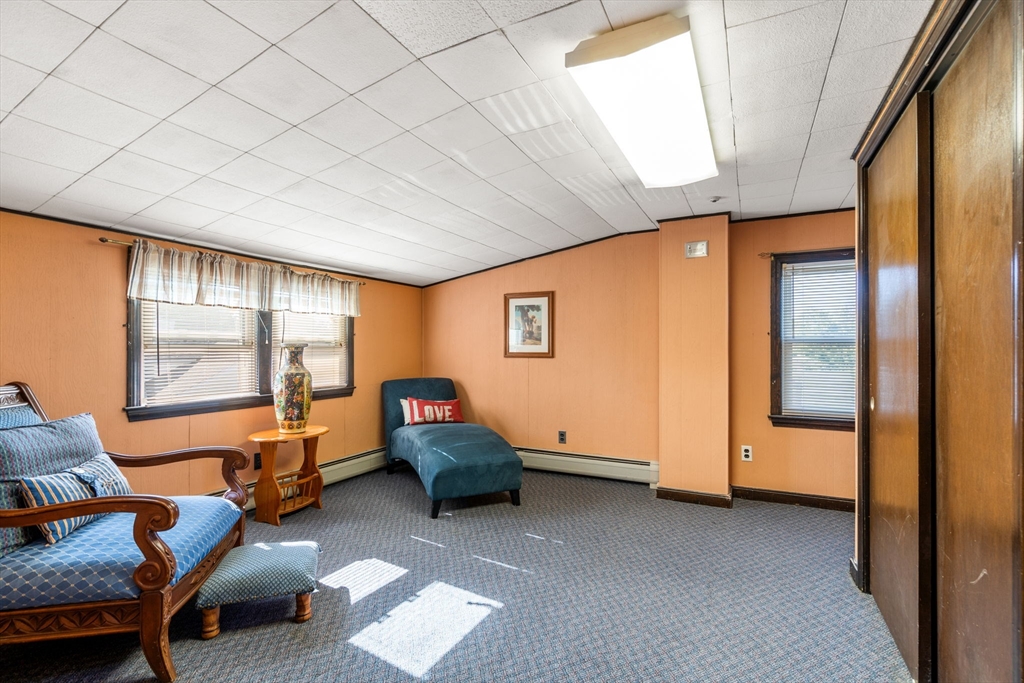 87 Waldeck Road Milton, MA 02186 - Photo 15 of 21 a view of game room with window and couch
