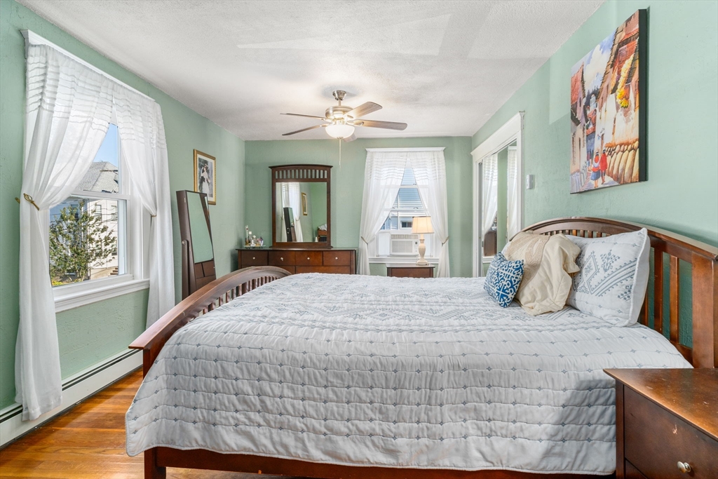 87 Waldeck Road Milton, MA 02186 - Photo 17 of 21 a bedroom with a large bed and a chandelier