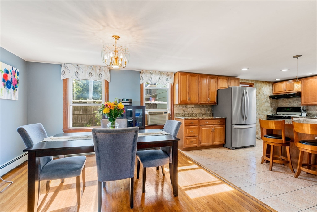 87 Waldeck Road Milton, MA 02186 - Photo 4 of 21 a dining room with furniture a chandelier and wooden floor