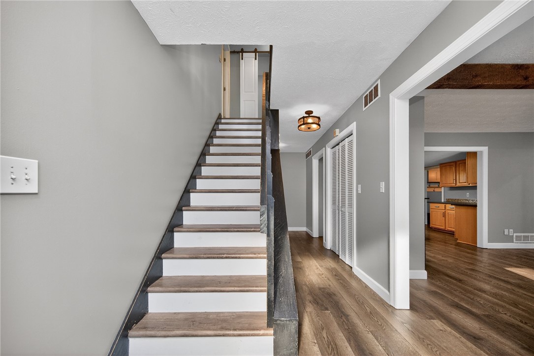 4747 Fawnwood Road Dayton, OH 45429 - Photo 8 of 58 This interior hallway features sleek flooring, a modern light fixture, and an inviting staircase.