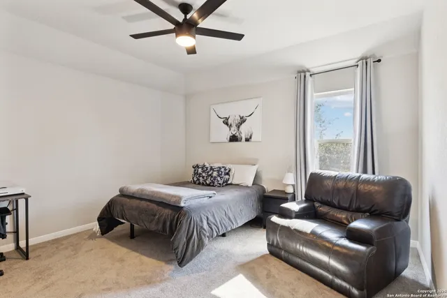 a bedroom with a bed couch and window