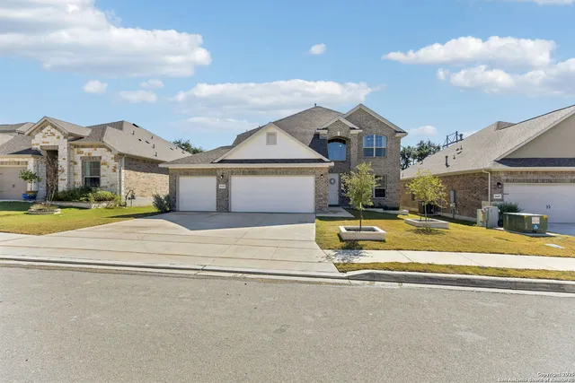 a view of a white house with a large pool and a yard