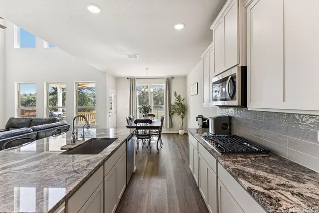 a kitchen with sink stove and cabinets